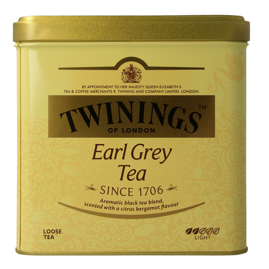 Twinings Earl Grey tea in a 500g blik, featuring black tea leaves infused with bergamot flavor, in a metal container.