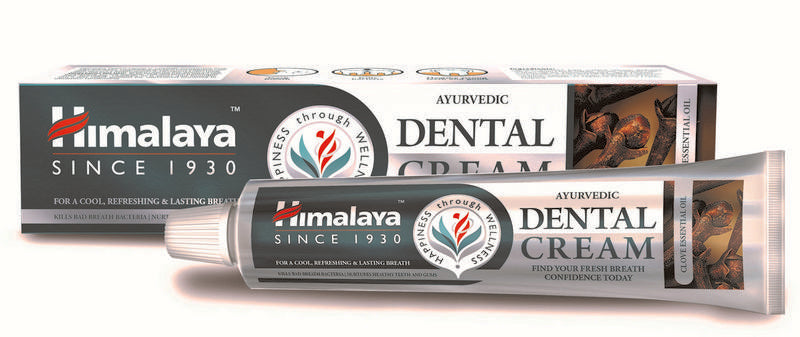 Himalaya Dental Cream Clove toothpaste in 100g tube, showing the packaging and product label.