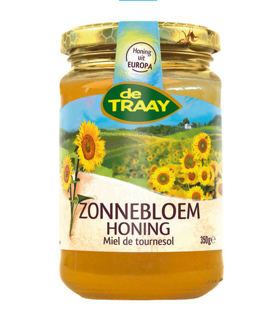 Jar of de Traay Zonnebloem honing with golden honey visible inside, labeled as 350 grams.