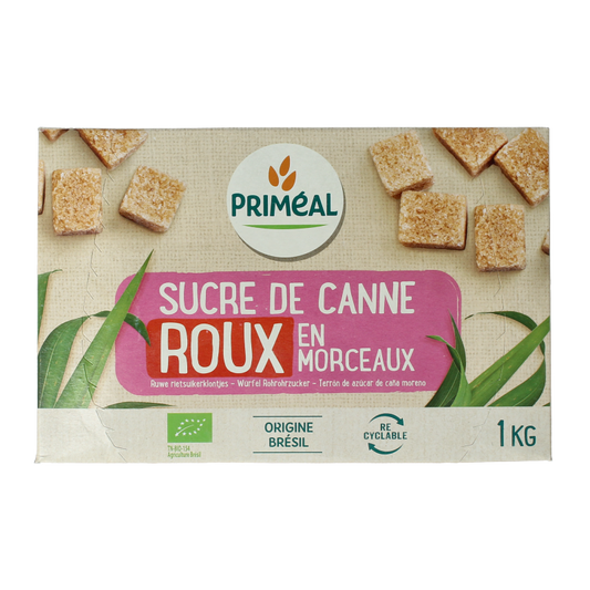 Primeal organic brown cane sugar lumps in a 1kg package, used for sweetening beverages and baking.