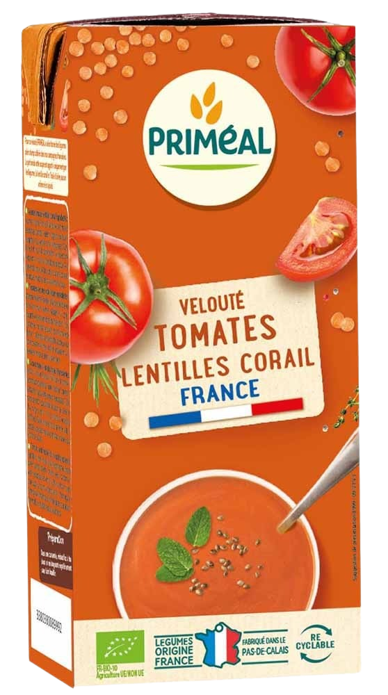 Primeal organic tomato and red lentil soup in a 330ml container, showing the prepared soup with tomato and lentils visible.