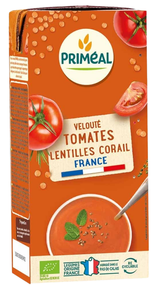 Primeal organic tomato and red lentil soup in a 330ml container, showing the prepared soup with tomato and lentils visible.