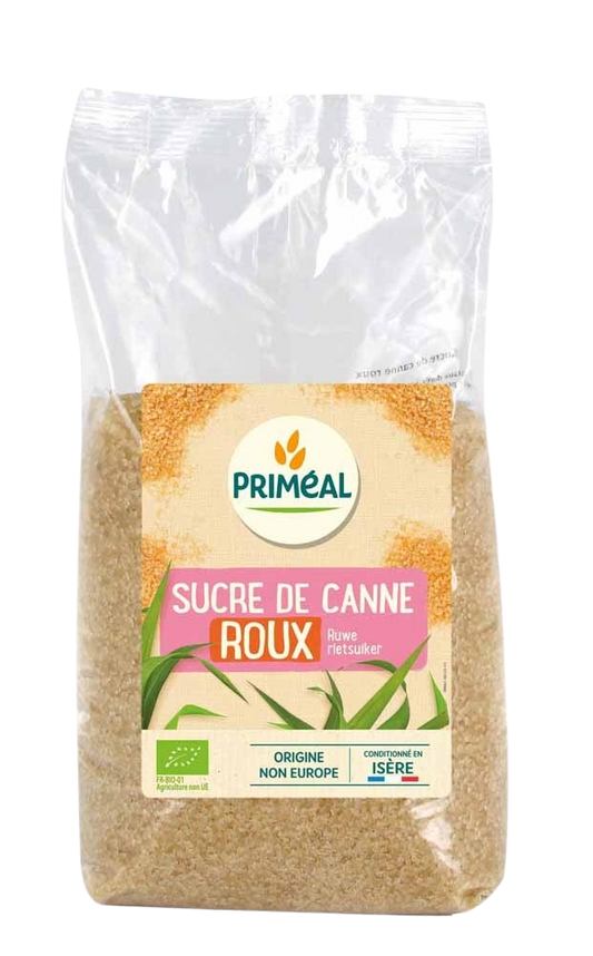 Primeal organic brown raw cane sugar in a 1kg bag, showing the textured, light brown sugar crystals for baking and sweetening