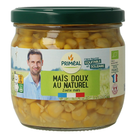 Canned organic Primeal corn in a 330g can, showing the label and contents of bright yellow corn kernels.