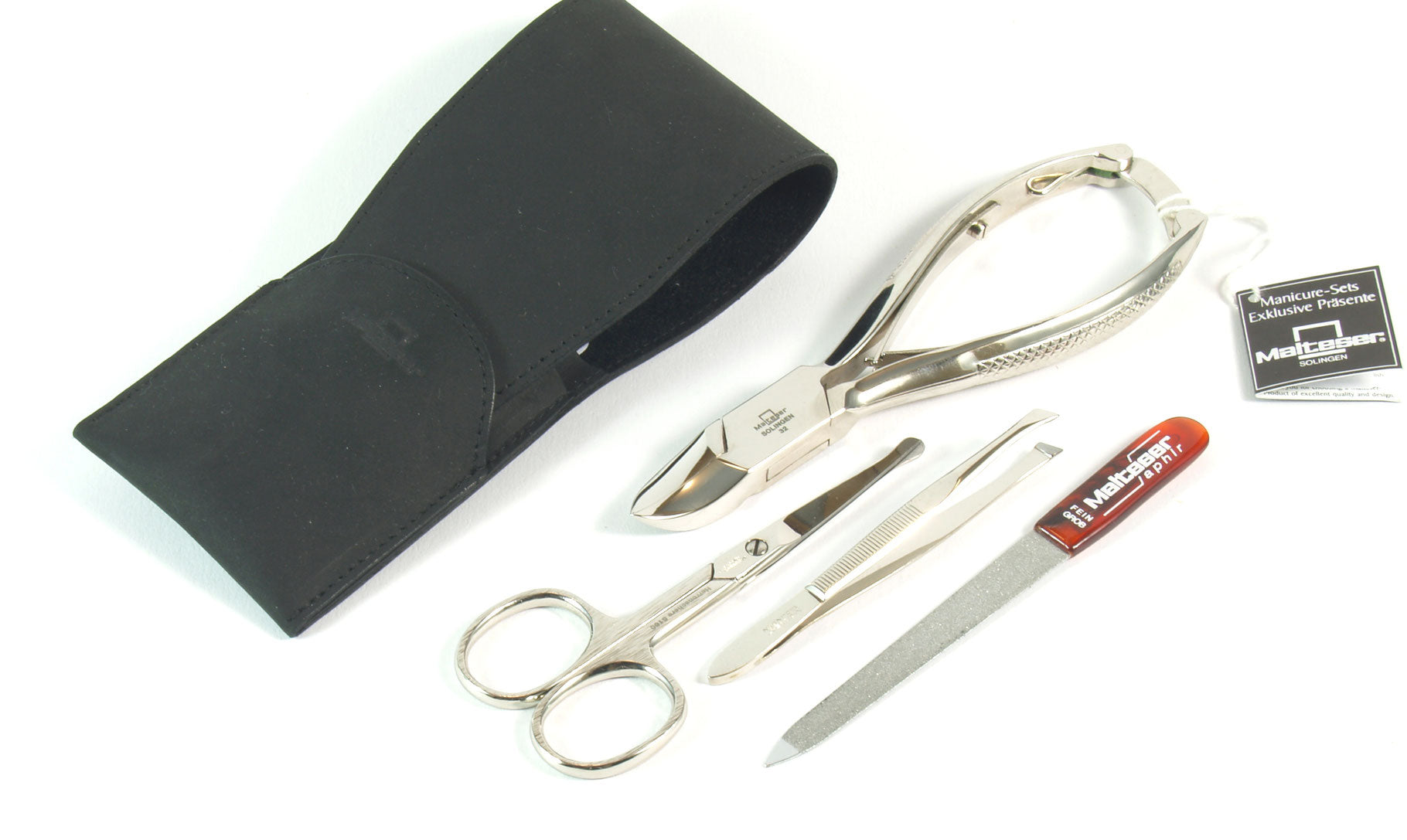 Malteser manicure and pedicure instrument set with four black leather Zaketui cases for nails and facial hair tools.