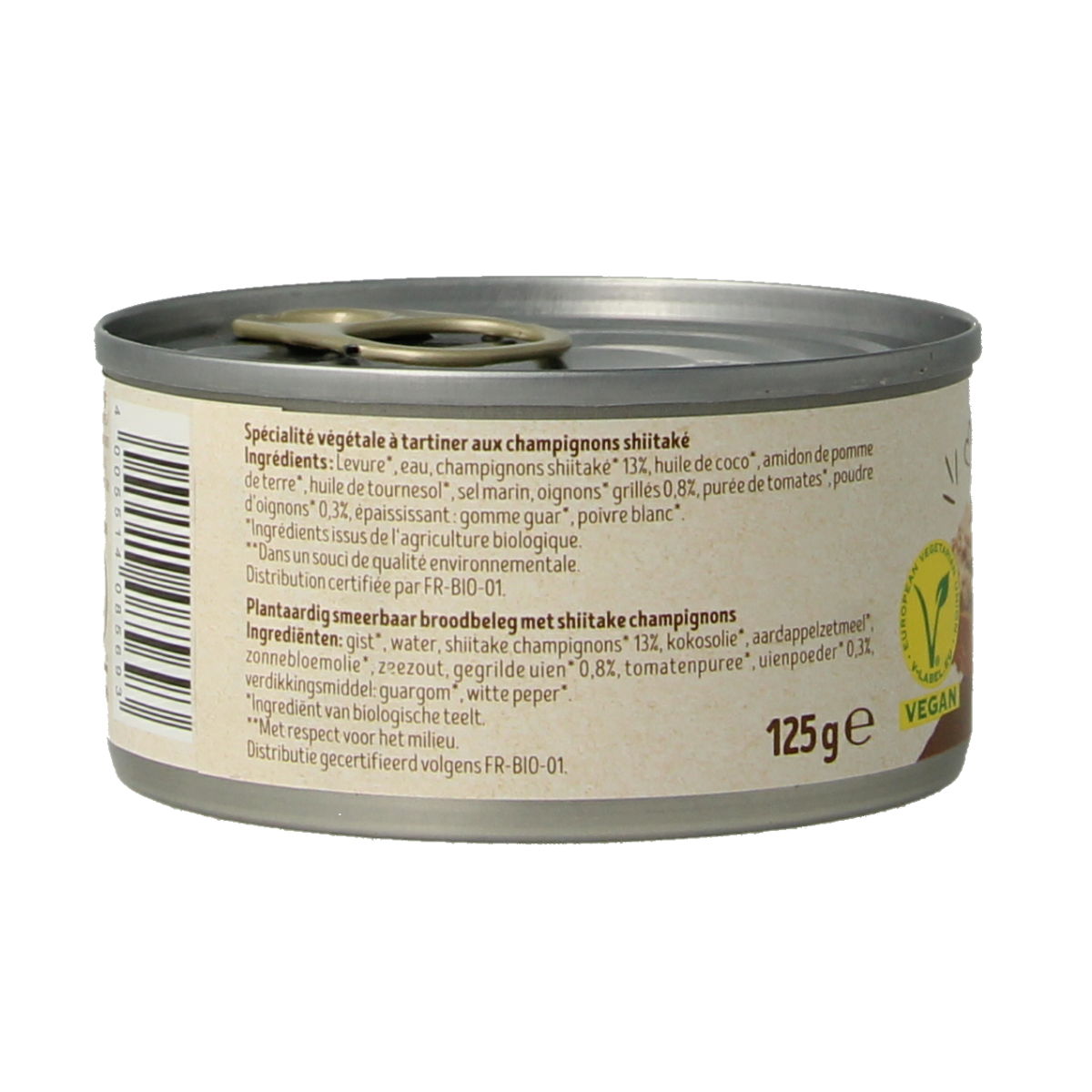 Tartex bio mushroom pate spread on bread, showing the 125g jar with mushroom and herb ingredients visible.