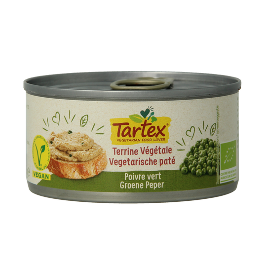 Tartex organic green pepper pate spread on bread, showcasing its vibrant green color and smooth texture in a close-up image.