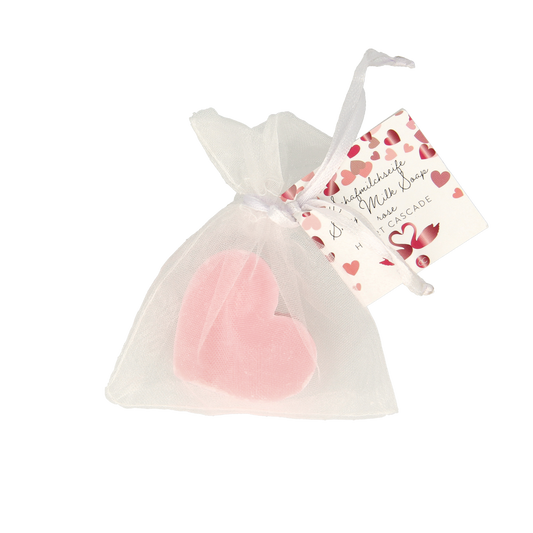 Sheep milk soap heart-shaped cascade by Merkloos, natural body care product, with white and soft pink colors.