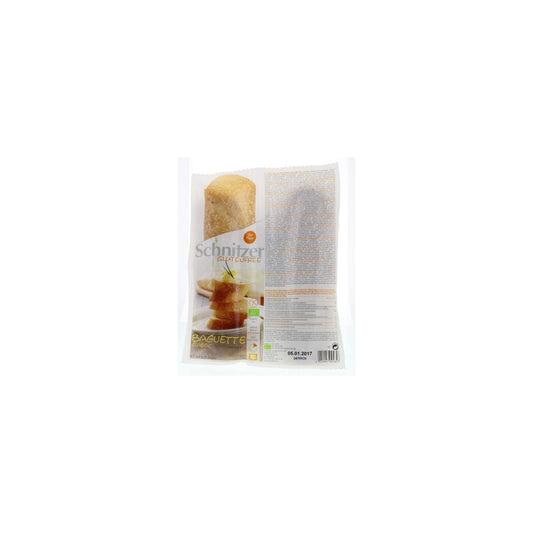 Schnitzer gluten-free organic baguette bread, whole and fresh, displayed on a wooden surface.
