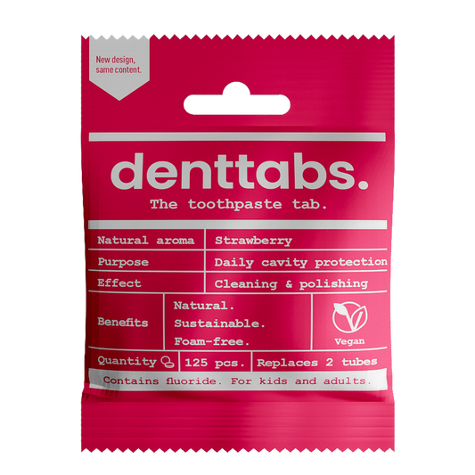 Denttabs vegan strawberry toothpaste tablets with fluoride, 125 pieces, natural dental hygiene product in a clear container.