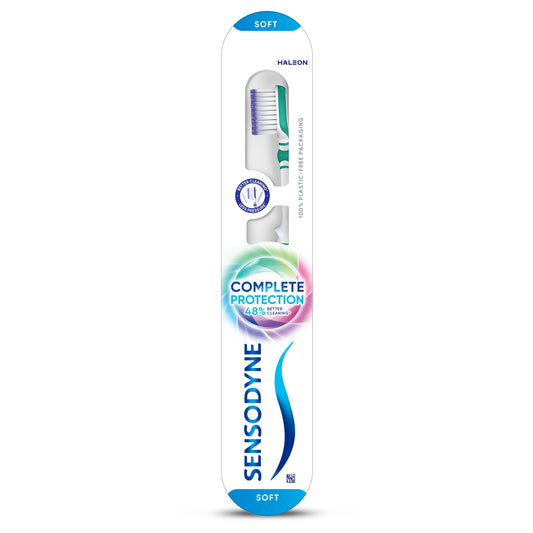 Sensodyne Complete Care toothbrush for sensitive teeth, featuring soft bristles and ergonomic handle in a close-up view.