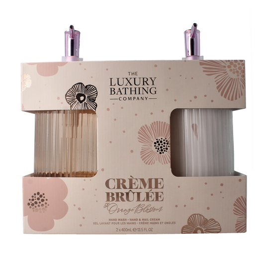 The Luxury Bathing Co Heavenly Hands hand wash and nail cream set in glass bottles, featuring elegant packaging and skincare products.