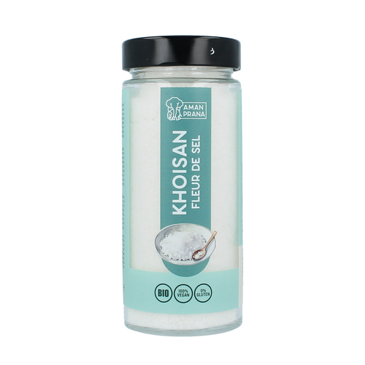 Amanprana Khoisan fleur de sel in a 300g container, showcasing coarse sea salt crystals on a natural surface.