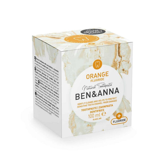 Ben & Anna orange fluoride toothpaste in 100g tube, natural oral care product with bright orange packaging and fresh citrus scent.