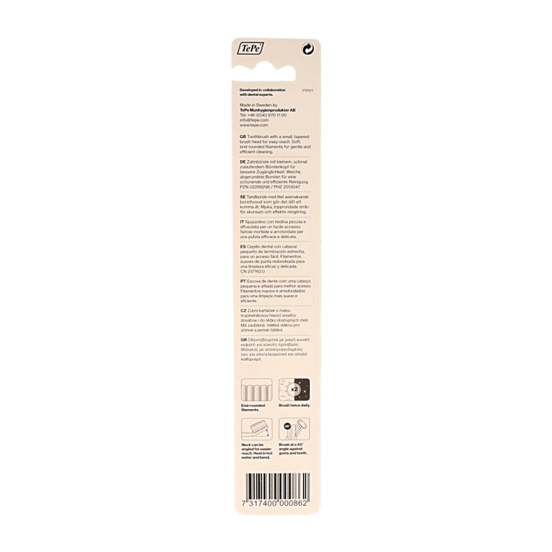 TePe Select Compact Soft toothbrush with white handle, designed for gentle cleaning, shown in close-up.