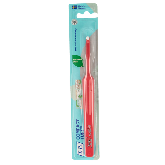 TePe compact tuft toothbrush in white with blue handle, designed for effective cleaning of hard-to-reach areas.
