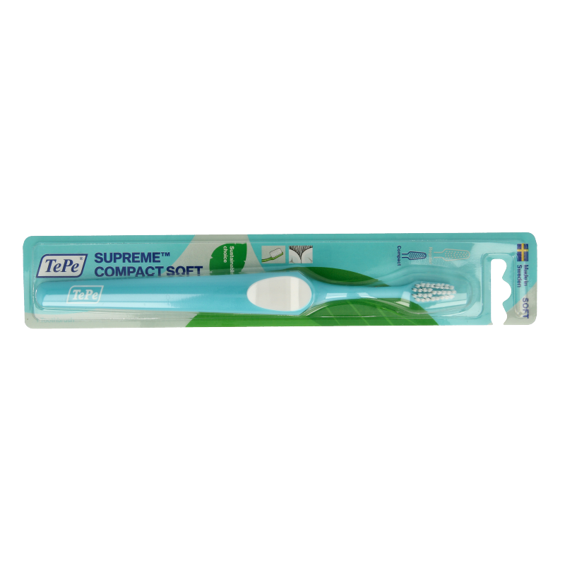 TePe Supreme Compact Soft toothbrush with pink handle, designed for gentle oral cleaning, shown in close-up.