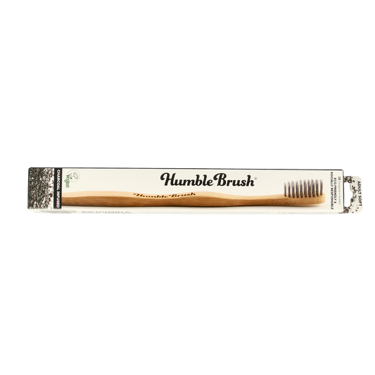Bamboo charcoal toothbrush by The Humble Co, eco-friendly Tandenborstel with soft bristles, natural wooden handle for oral hygiene.