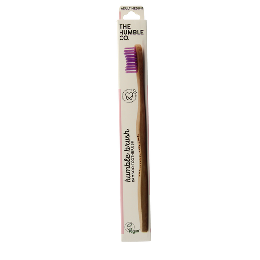 The Humble Co bamboo medium purple toothbrush with biodegradable handle and soft bristles, designed for eco-friendly oral care.