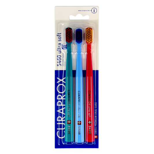 Set of three Curaprox CS 5460 ultra soft toothbrushes with colorful handles, designed for gentle and effective oral cleaning.