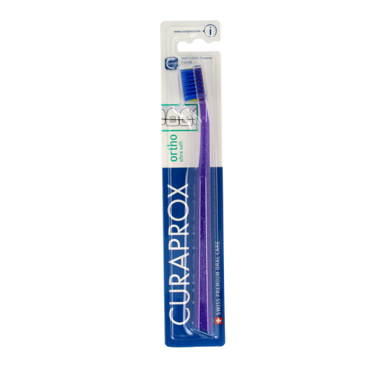 Curaprox CS Ortho Ultra Soft toothbrush with a white handle and soft bristles for orthodontic dental care.