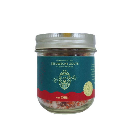 Glass jar of Zeeuwsche Zoute chili salt with 100 grams label, containing seasoned salt blend for cooking and seasoning.