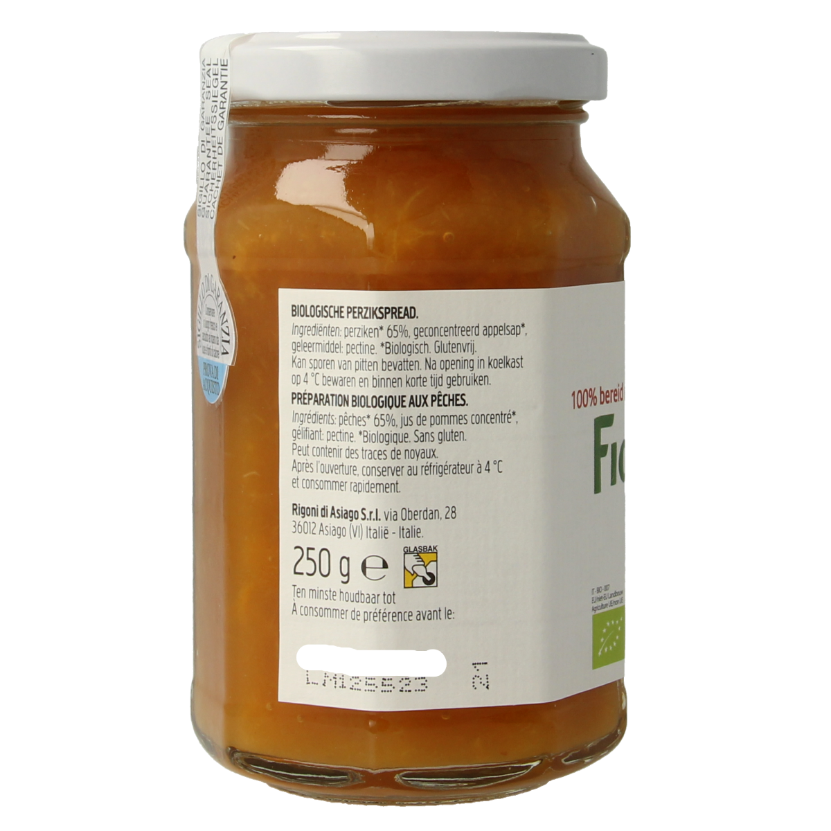 Fiordifrutta Perzikjam bio spread on bread, showcasing a jar of peach organic fruit spread with a spoon.