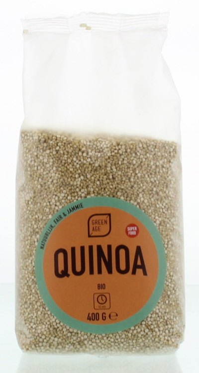 Greenage organic quinoa in a 400g package, shown with fresh vegetables and potatoes on a grocery store display.