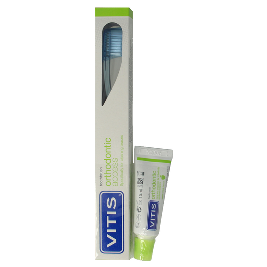 Vitis orthodontic access brush with sample toothpaste for dental prostheses, designed for cleaning orthodontic appliances.
