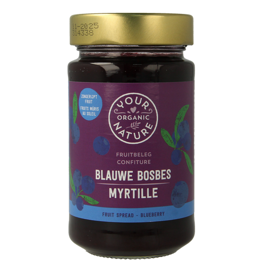 Organic blueberry jam spread by Your Organic Nature on bread, showing fresh blueberries and jam texture in a jar.