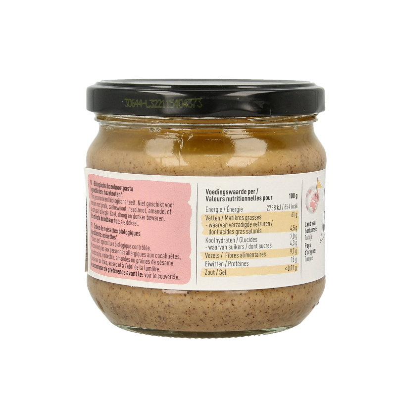 Organic Nice & Nuts hazelnut spread on bread, 330g jar, creamy and nutty with textured surface, ideal for breakfast or snacks.