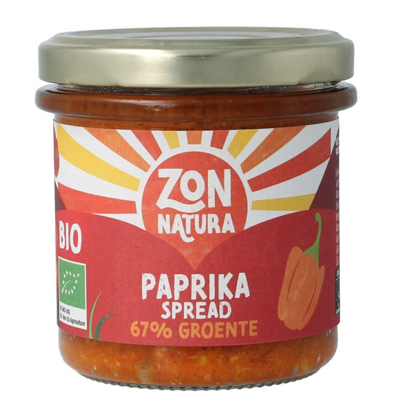 Zonnatura Groentespread paprika bio on bread, showcasing the vibrant orange spread in a jar with a spoon.