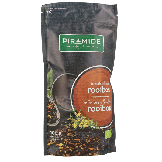 Organic Piramide Rooibos tea pyramid infuser, 100g, in a natural, colorful tea bag with fresh rooibos leaves visible.