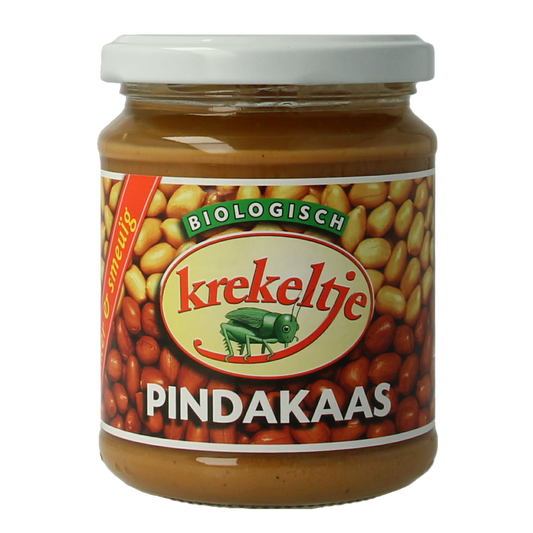 Krekeltje organic peanut butter with salt in a 250g jar, spread on bread, showing the label and creamy texture.