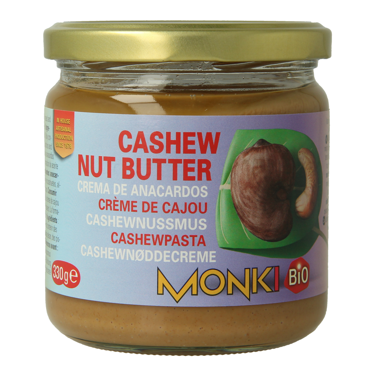 Monki Cashewpasta bio bread spread jar, 330 grams, with a creamy texture and nutty flavor, shown with a spoon and bread slices.