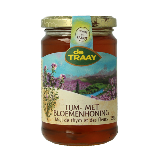Jar of de Traay thyme honey with flower nectar, 350g, showcasing the honey's golden color and floral infusion.