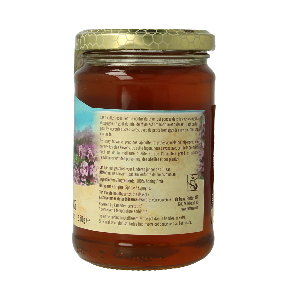 De Traay tijm honey with flowers, 350g jar showing golden honey with floral accents and a natural honeycomb lid.
