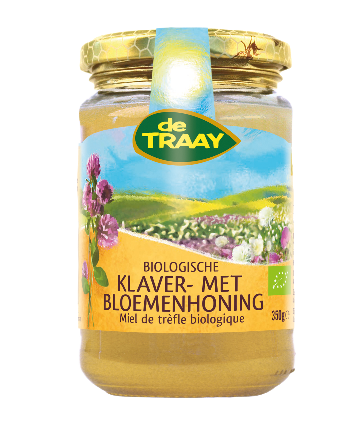 Jar of de Traay organic flower honey, 350g, with honeycomb and flowers visible in the clear glass container.