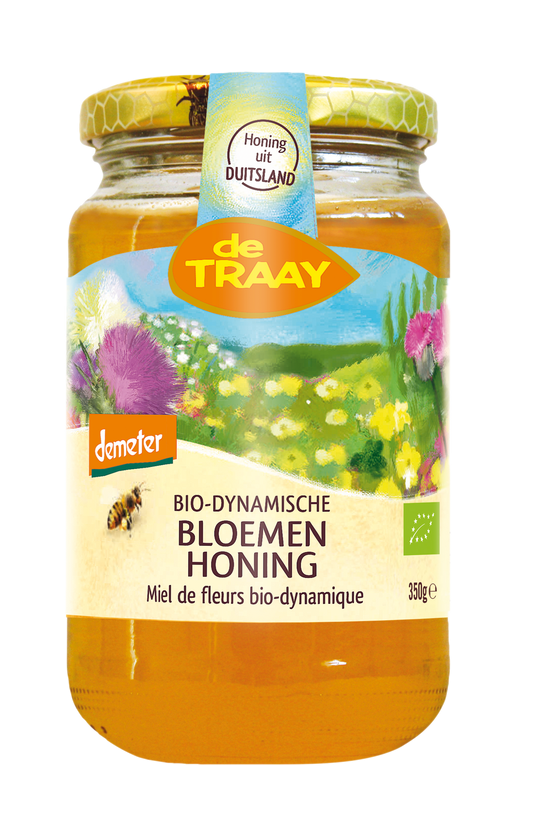 De Traay bio-dynamisch bloemenhoning in 350g jar, golden honey with floral aroma, label visible on the jar.