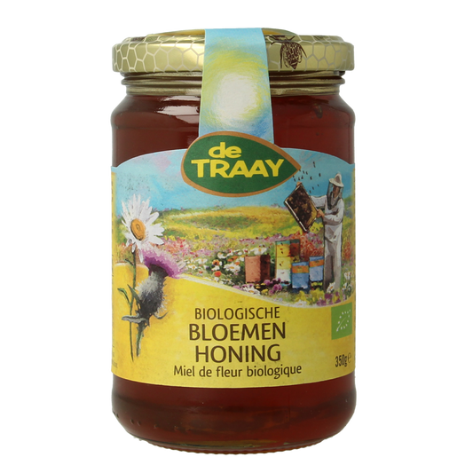 de Traay biologisch vloeibare bloemenhoning in 350g pot, close-up of golden honey with floral details