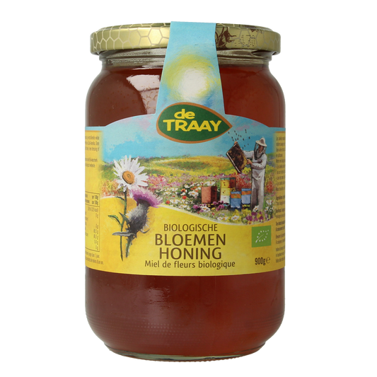 Liquid bio honey from de Traay, 900 grams, showing a jar with golden, viscous honey and fresh flowers in the background.