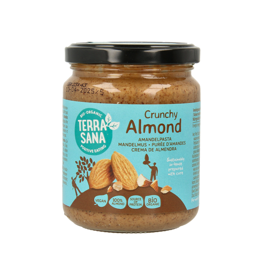 Crunchy organic almond butter spread by TerraSana on whole grain bread, showing the jar and spread texture.