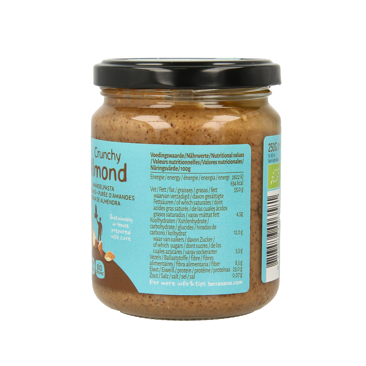 Crunchy brown almond paste spread by TerraSana on bread, showing its textured surface and packaging label.