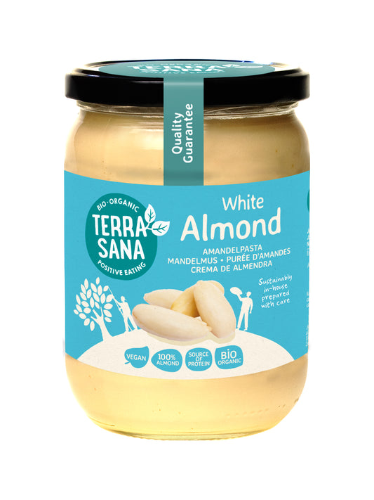 Organic TerraSana white almond butter spread on bread, 500g jar, natural almond flavor, suitable for a healthy breakfast.