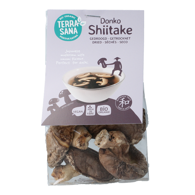 Organic TerraSana Shiitake Donko mushrooms in a 25g package, displayed with fresh vegetables and fruit.