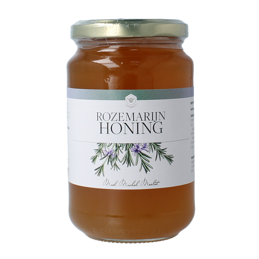 Jar of Michel Merlet Rozemarijn honey, 500g, showcasing the honey's golden color and rosemary infusion in a clear glass jar.