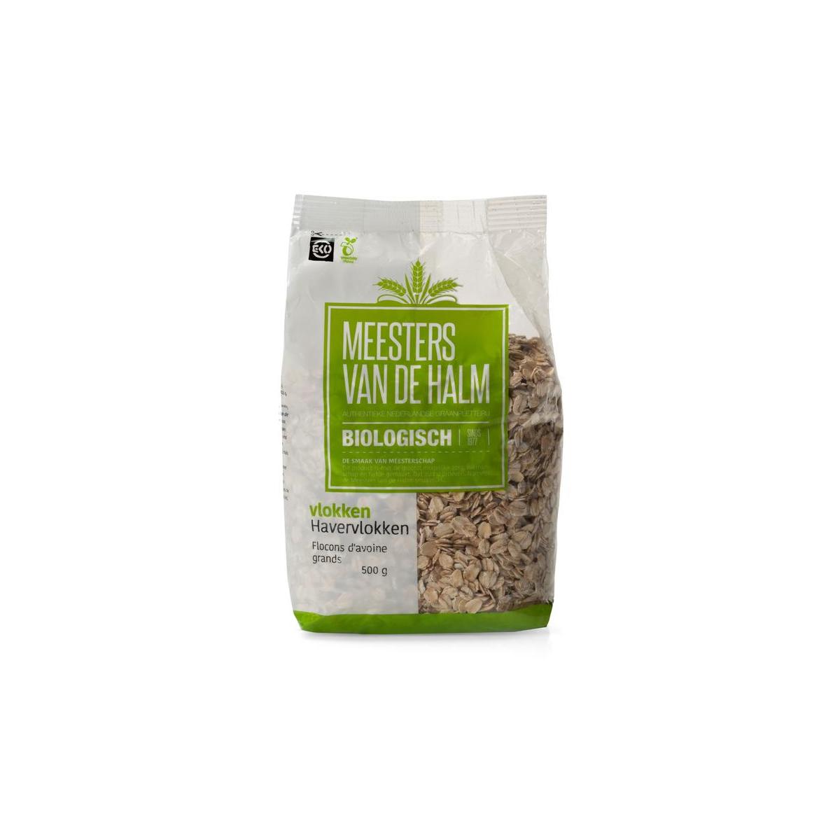 De Halm grof biologische havervlokken ontbijtgranen in 500g pack, close-up of textured oats in a clear bowl.