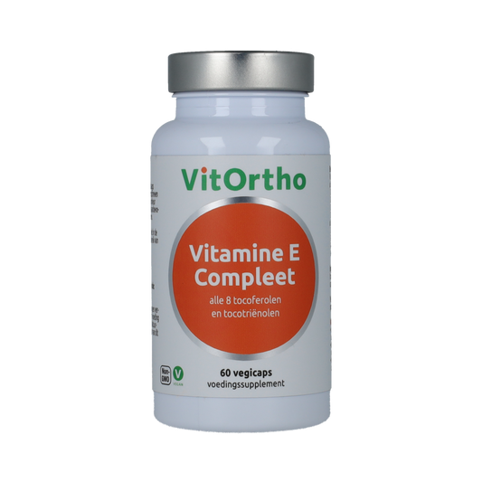 Vegetarian VitOrtho Vitamin E capsules in a bottle, close-up of the product label and capsules on a white background.