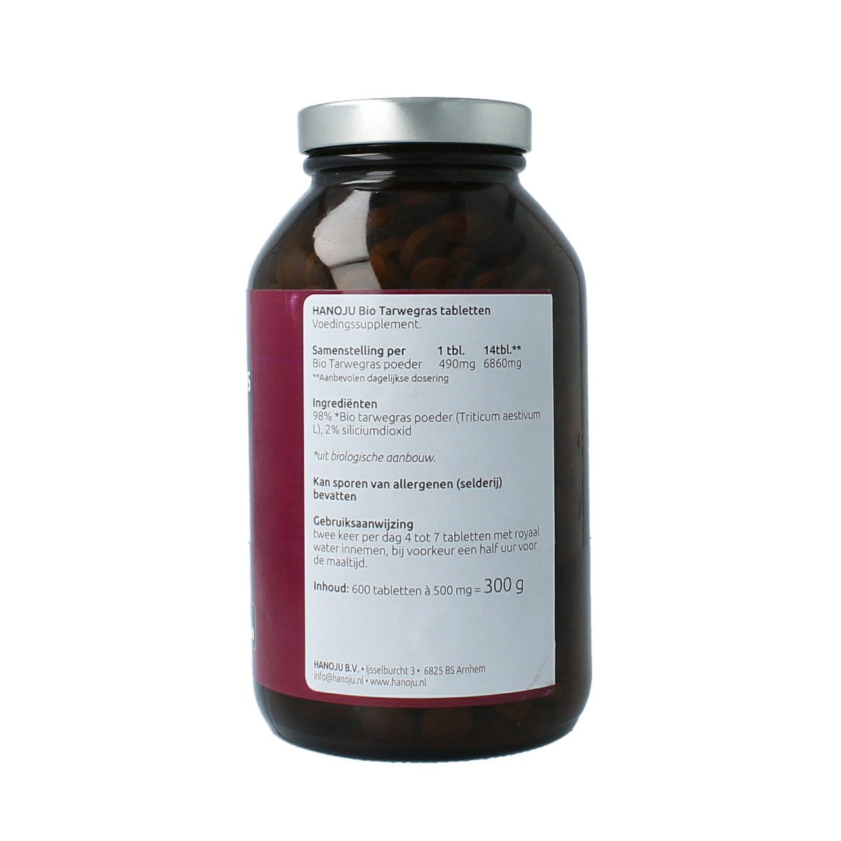 Hanoju Tarwegras bio tablets in glass bottle, herbal supplement for health, with green wheatgrass tablets visible inside.