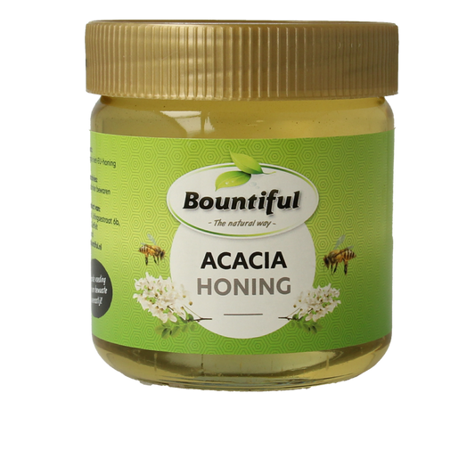 Bountiful Bountiful Acacia honing 500g jar showing golden honey with a wooden honey dipper and acacia flowers in the background.